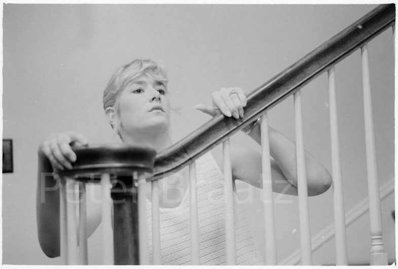 Laura Dern sitting on the stairs